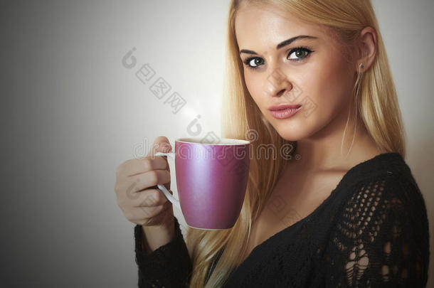 美女喝酒咖啡。金发喝杯茶的女孩
