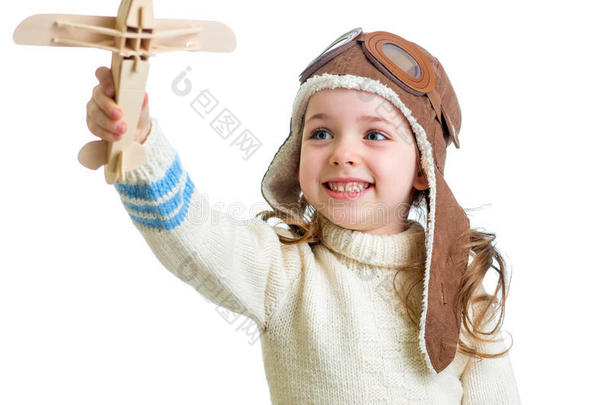 快乐的孩子穿上飞行员的衣服，玩着木制的飞机玩具