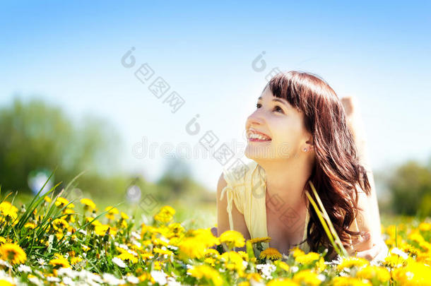 年轻快乐的美女躺在草地上，花儿<strong>朵朵</strong>