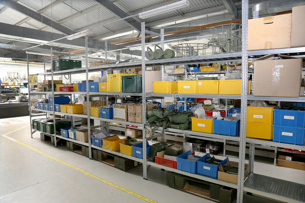 现代化工厂仓库上的机械现代化厂房，彩色塑料包装盒，金属货架上的个人防护用品