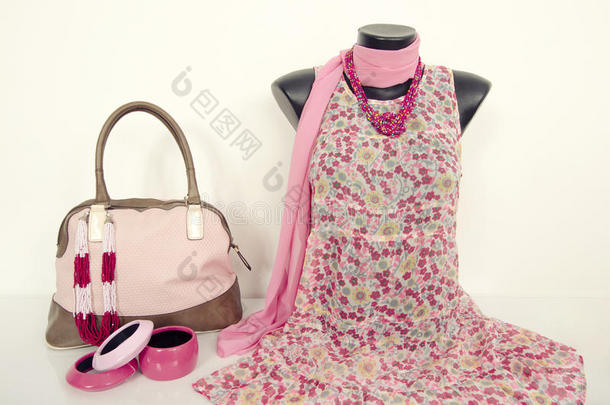 人体模特上的粉色花朵连衣裙，配有配套配件。