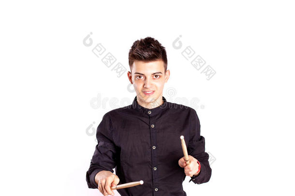 一个鼓手穿着黑色的鼓手在画室里玩鼓