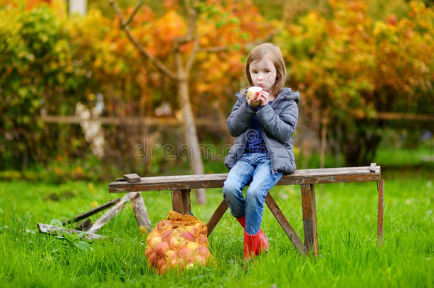 秋天坐在长凳上的小女孩