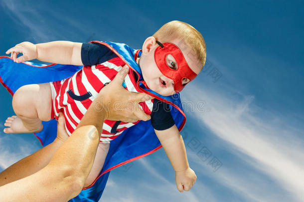 快乐的小男孩穿着超级英雄服装飞翔