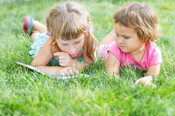 年轻快乐的孩子，在自然背景下读书的孩子