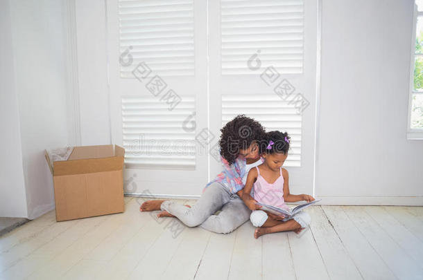 母女俩坐在地板上读故事书