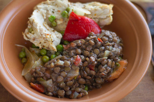 传统的鸡肉和扁豆炖在自制的陶瓷盘子里