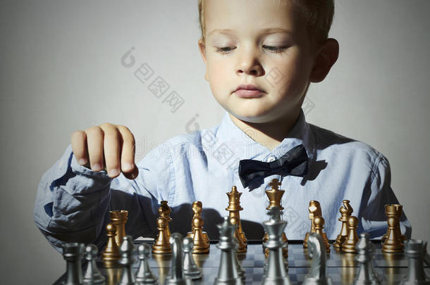 小男孩在玩象棋。聪明孩子。天才孩子。聪明的游戏棋盘