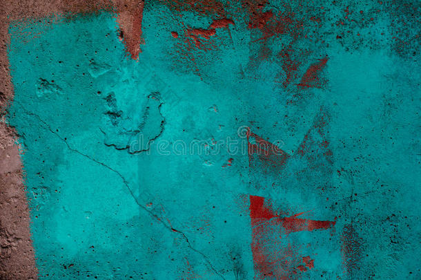 蓝色和红色的油漆笔触在肮脏的混凝土墙上