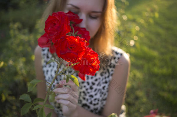 金色的夕阳余晖映照下女孩脸上的红玫瑰