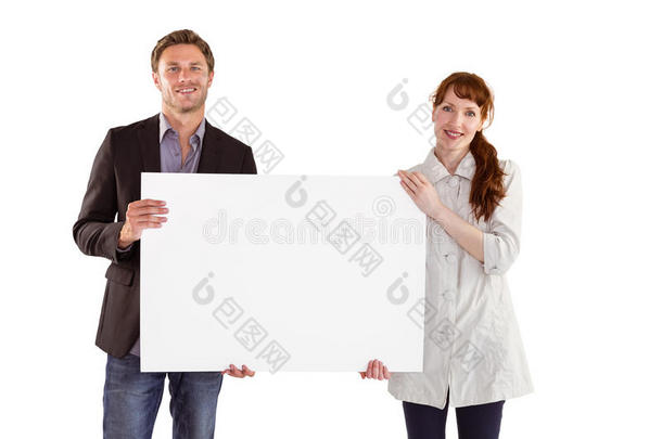 微笑的夫妇举着大牌子