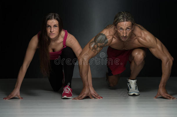 强壮有力的夫妇跪在地板上