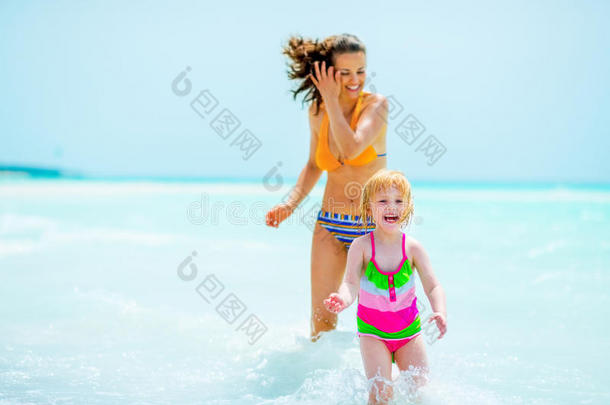 快乐的妈妈和小女孩在<strong>海边玩耍</strong>