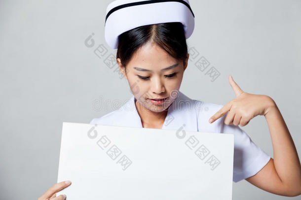 年轻的亚洲护士指着空白的牌子