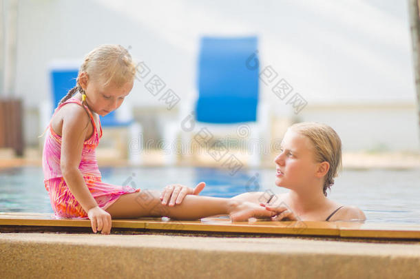 <strong>游泳池</strong>里的妈妈和<strong>游泳池</strong>边的女儿在tr里开心地聊天