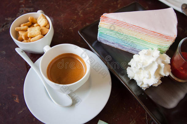 黑咖啡，配饼干和甜蛋糕，放在木桌上，让人们在咖啡厅放松一下。