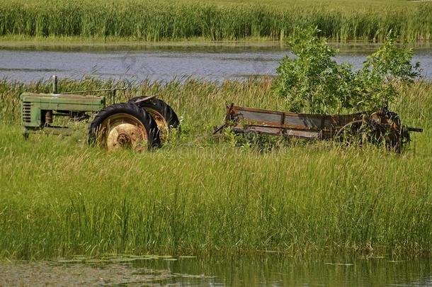 绿色拖拉机和旧肥料撒布机
