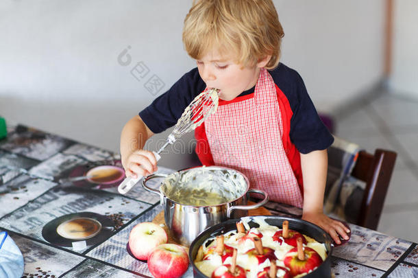 小男孩在家里的厨房里帮忙烤苹果派