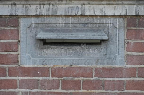一个老式的古色古香的邮箱（或信箱、邮箱、邮箱）位于红砖墙上