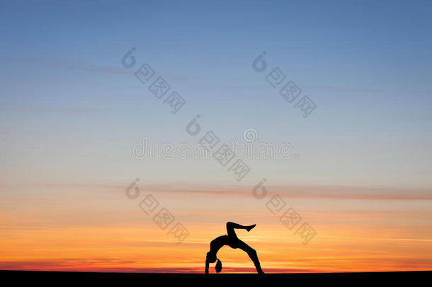 剪影体操运动员在夕阳下鞠躬
