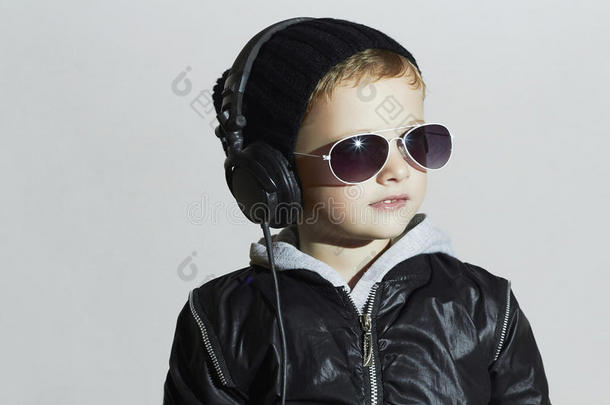 小dj。戴着墨镜和耳机的滑稽男孩。听音乐的孩子