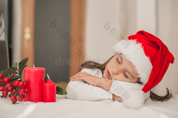 可爱的小女孩戴着圣诞帽睡觉的小女孩