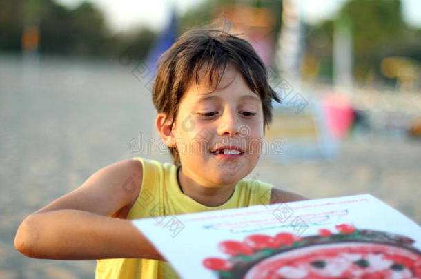 在日落海滩<strong>吃外卖</strong>披萨的男孩