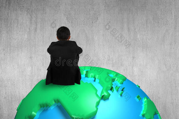 商人坐在3d地图地球仪上观看空白的混凝土墙