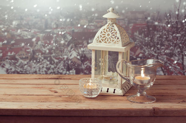 复古灯笼与蜡烛覆盖冬季小镇背景与复制空间