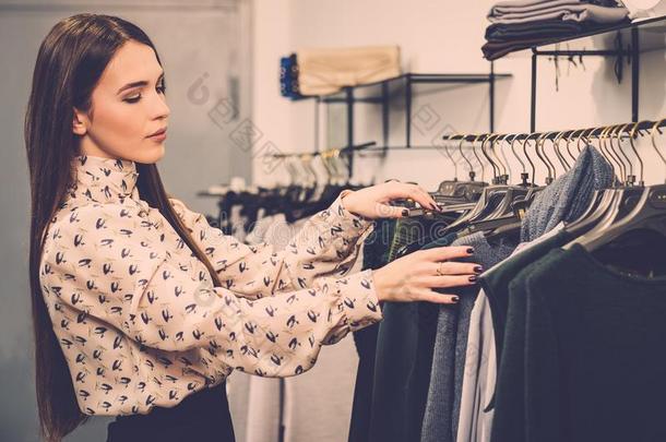 在陈列室挑选衣服的女人