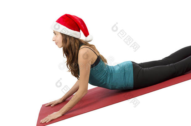 圣诞<strong>瑜珈</strong>女<strong>瑜珈</strong>师在瑜伽时摆眼镜蛇姿势