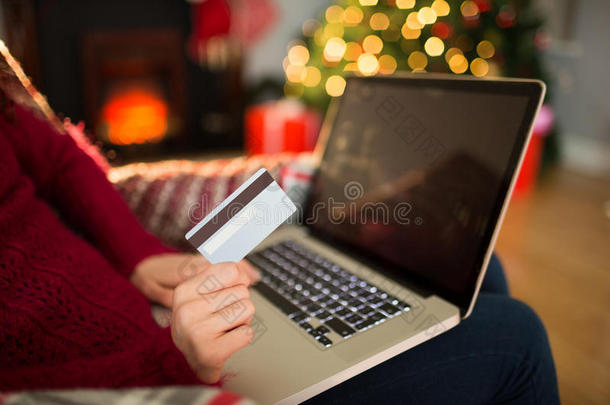 圣诞节妇女用笔记本电脑上网购物