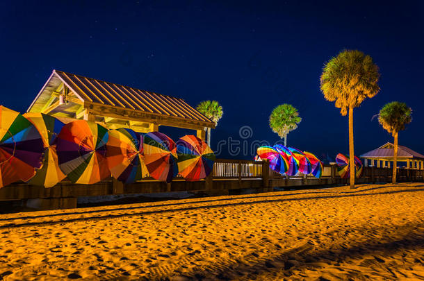 棕榈树和五颜六色的沙滩伞在晚上在清水b