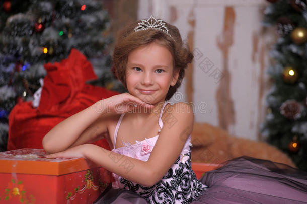 一个穿着<strong>漂亮衣服</strong>的女孩在圣诞节有很多礼物