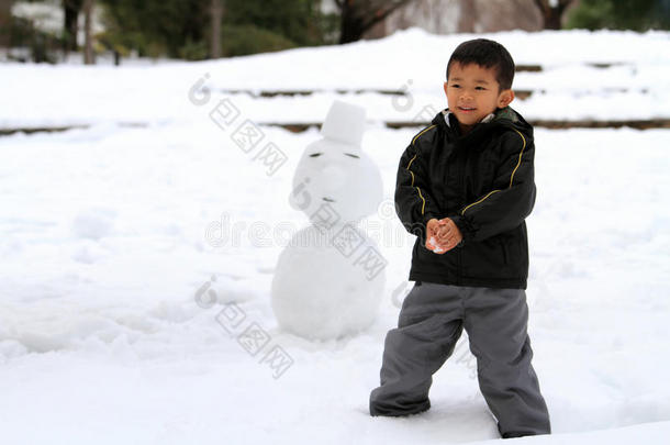 打雪仗和堆雪人的日本男孩