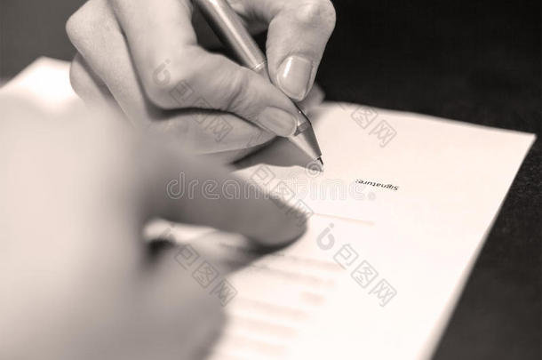 两个人的手在文件上<strong>签</strong>字。