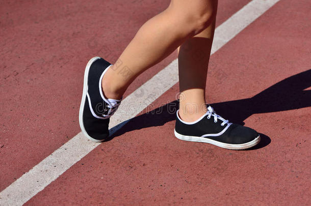脚女孩穿着运动鞋在跑步机上