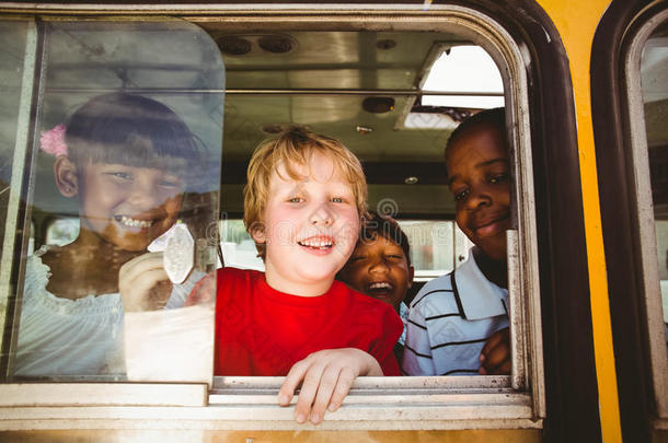 可爱的小学生在校车上对着摄像机微笑