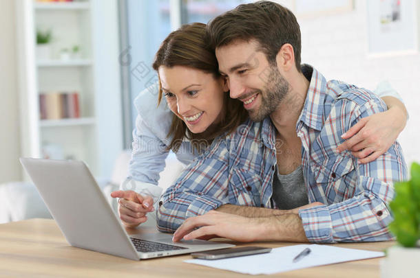 一对夫妇在家上网使用笔记本电脑