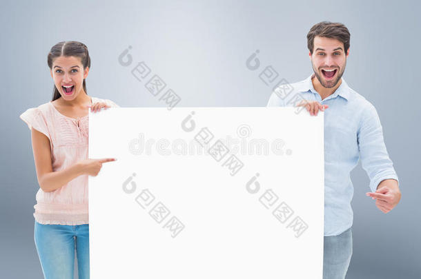 有吸引力的年轻夫妇微笑着拿着海报的复合图像