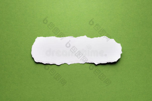 绿色背景上的一张撕破的纸