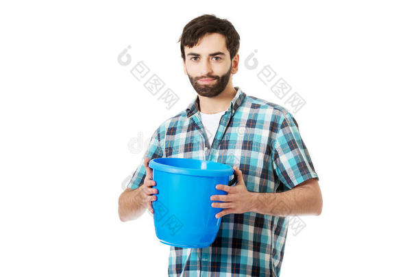 英俊的男人拿着塑料桶。