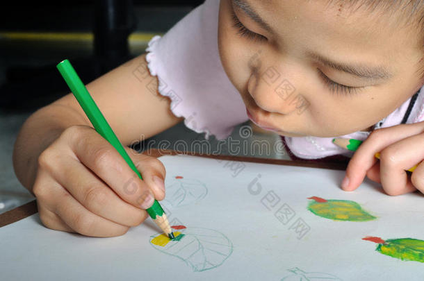 特写小亚洲女孩用<strong>彩色铅笔画</strong>她的画