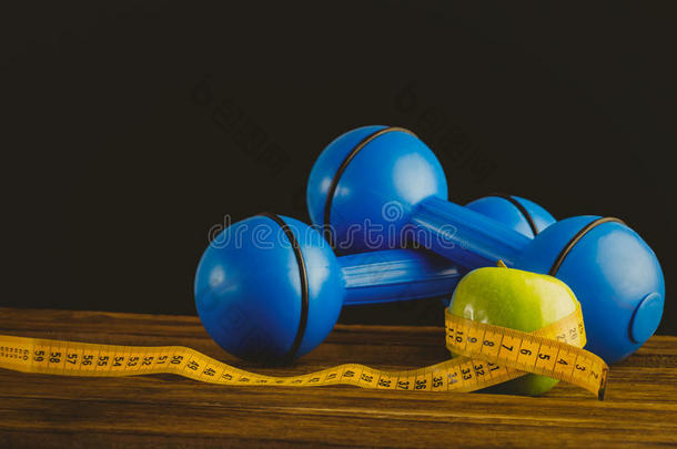 蓝色哑铃，绿色苹果和测量带