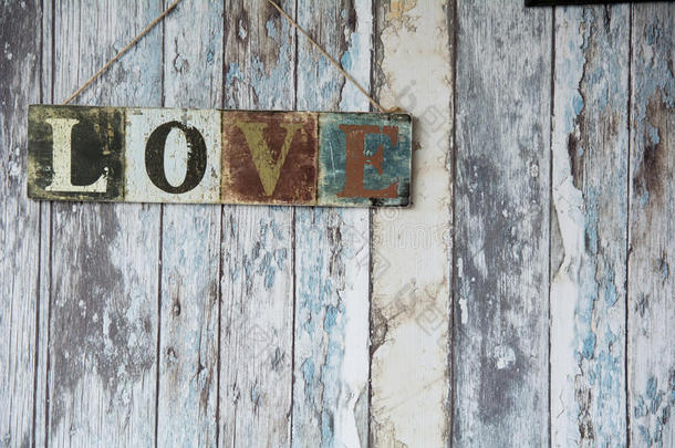 一个标志，在老墙<strong>的</strong>背景上有“爱”这个词
