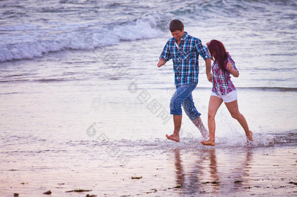 一对夫妇在海滩上跑步