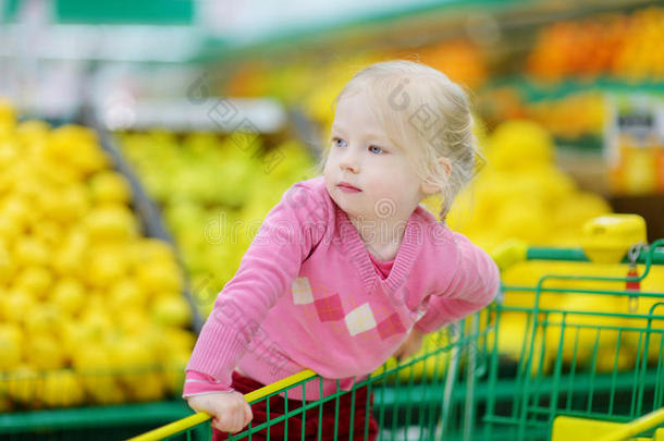 可爱的小女孩在一家<strong>食品店</strong>购物