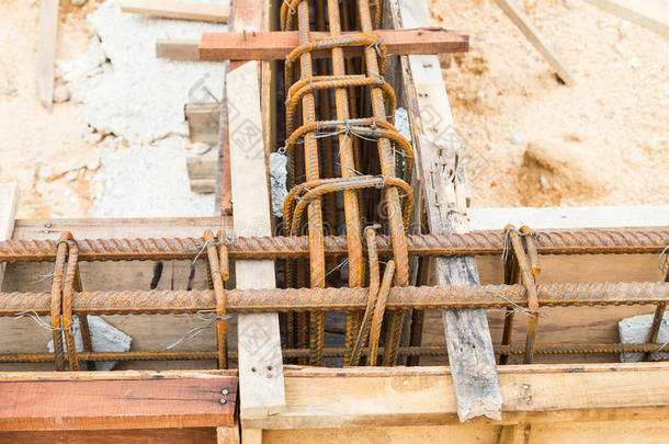 在施工现场用钢棒封闭木模，形成基础梁