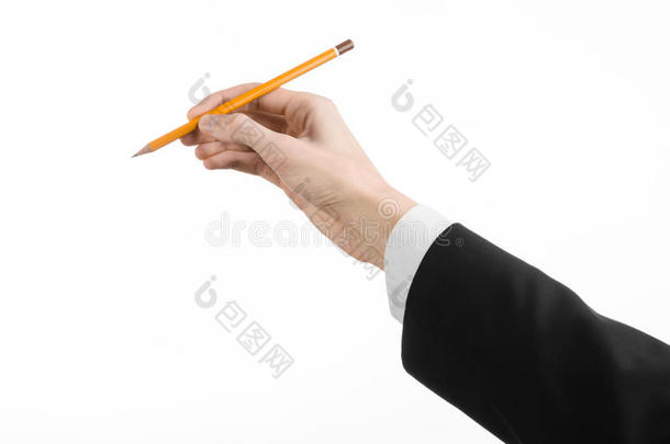 绘画和设计主题：艺术家的手，穿着黑色西装，拿着一支铅笔，孤立在工作室的白色背景上