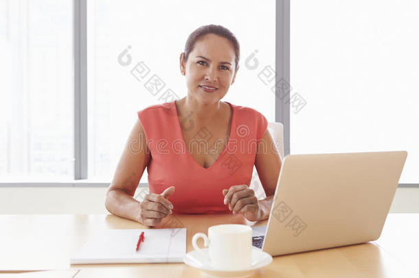 女商人在会议室桌子上用笔记本电脑工作